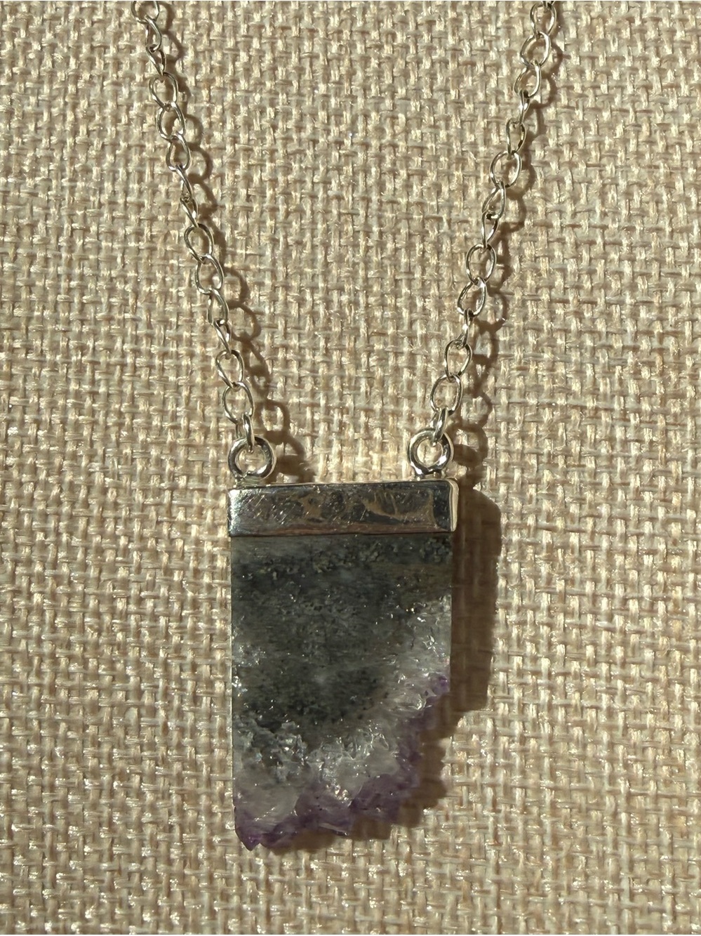 Sterling Silver Necklace featuring a raw, rectangular slice of amethyst quartz.
